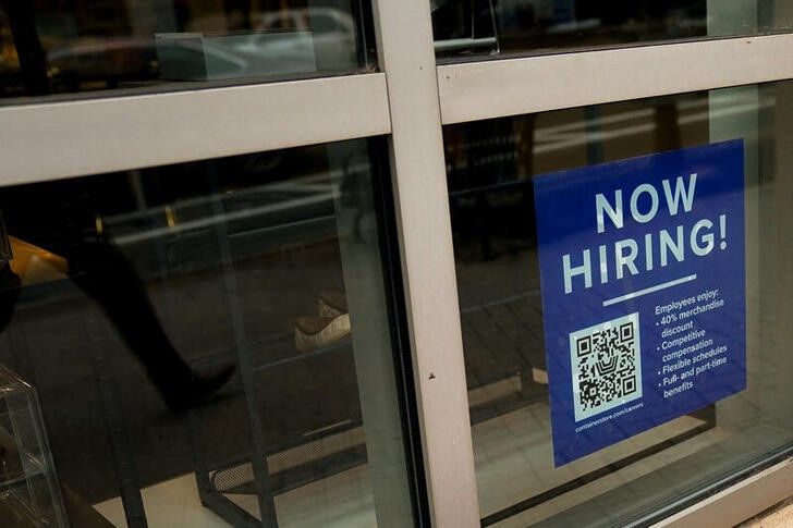 File image of a job offer sign in the window of a business in Arlington, Virginia, USA.  April 7, 2023. REUTERS/Elizabeth Frantz
