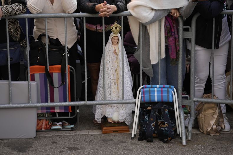 Faithful, next to an image of the Virgin of Fatima, await the arrival of Pope Francis at the sanctuary of Fatima, in Fatima, central Portugal, on August 5, 2023. (AP Photo/Francisco Seco)