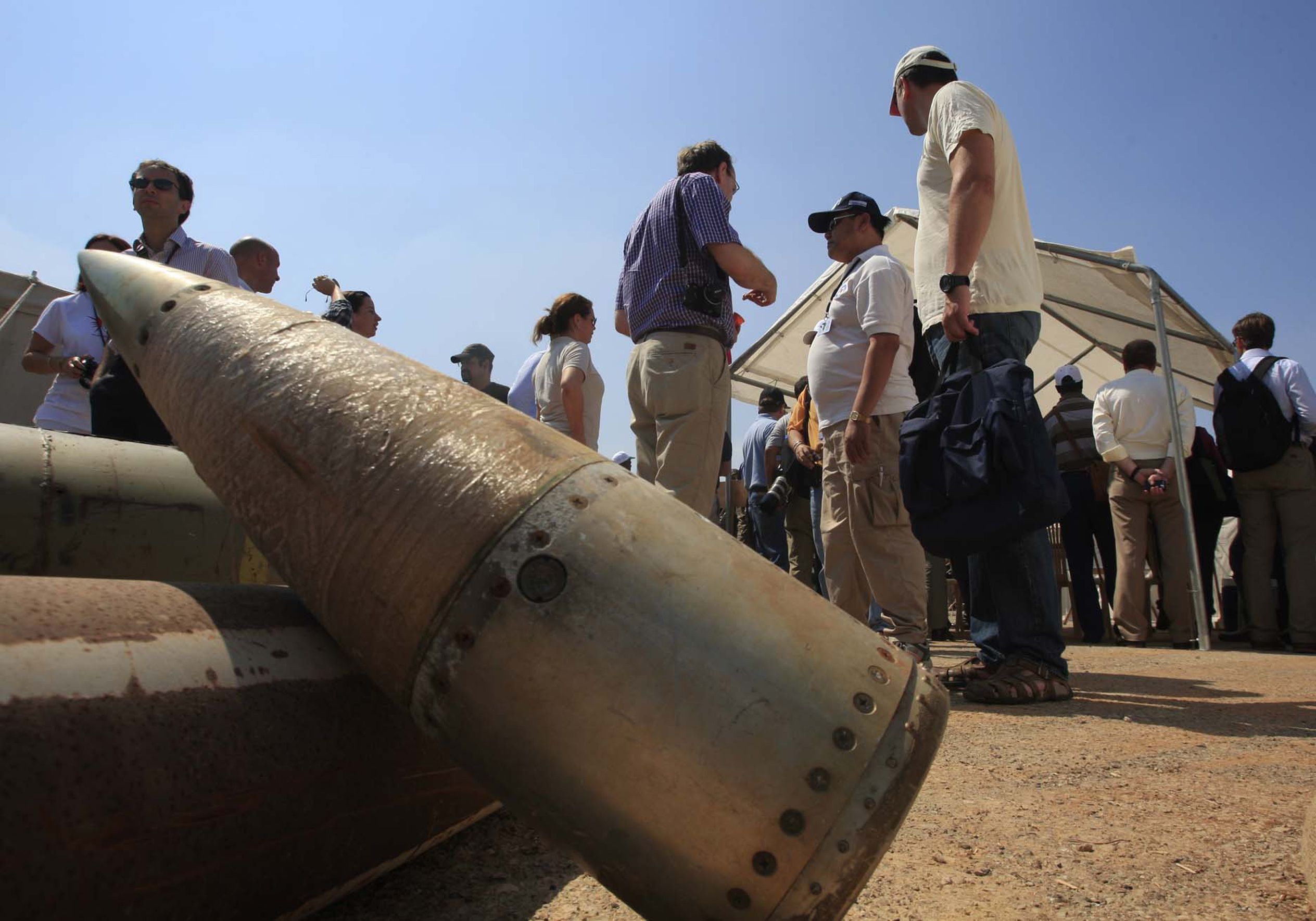 Activists and international delegations are next to cluster bombs.  (AP)
