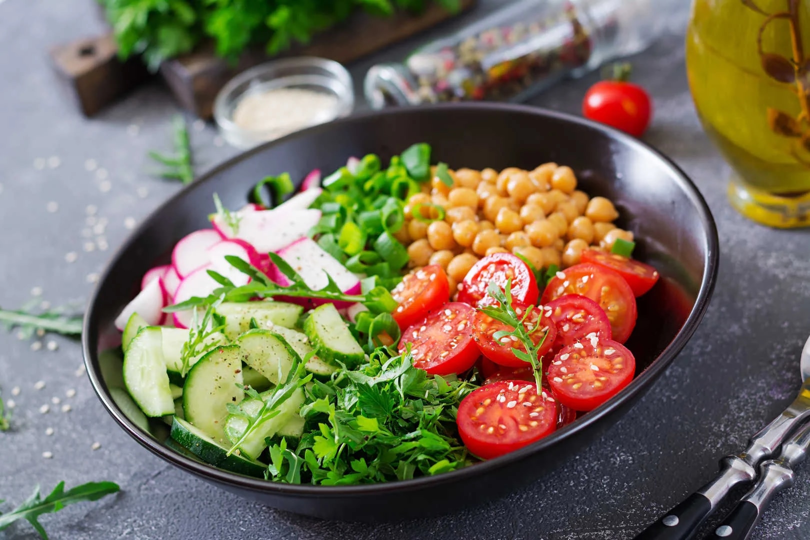 Diet food, buddha bowl vegan salad: chickpeas, tomatoes, cucumbers, radishes, greens.  Courtesy: Cluvi.