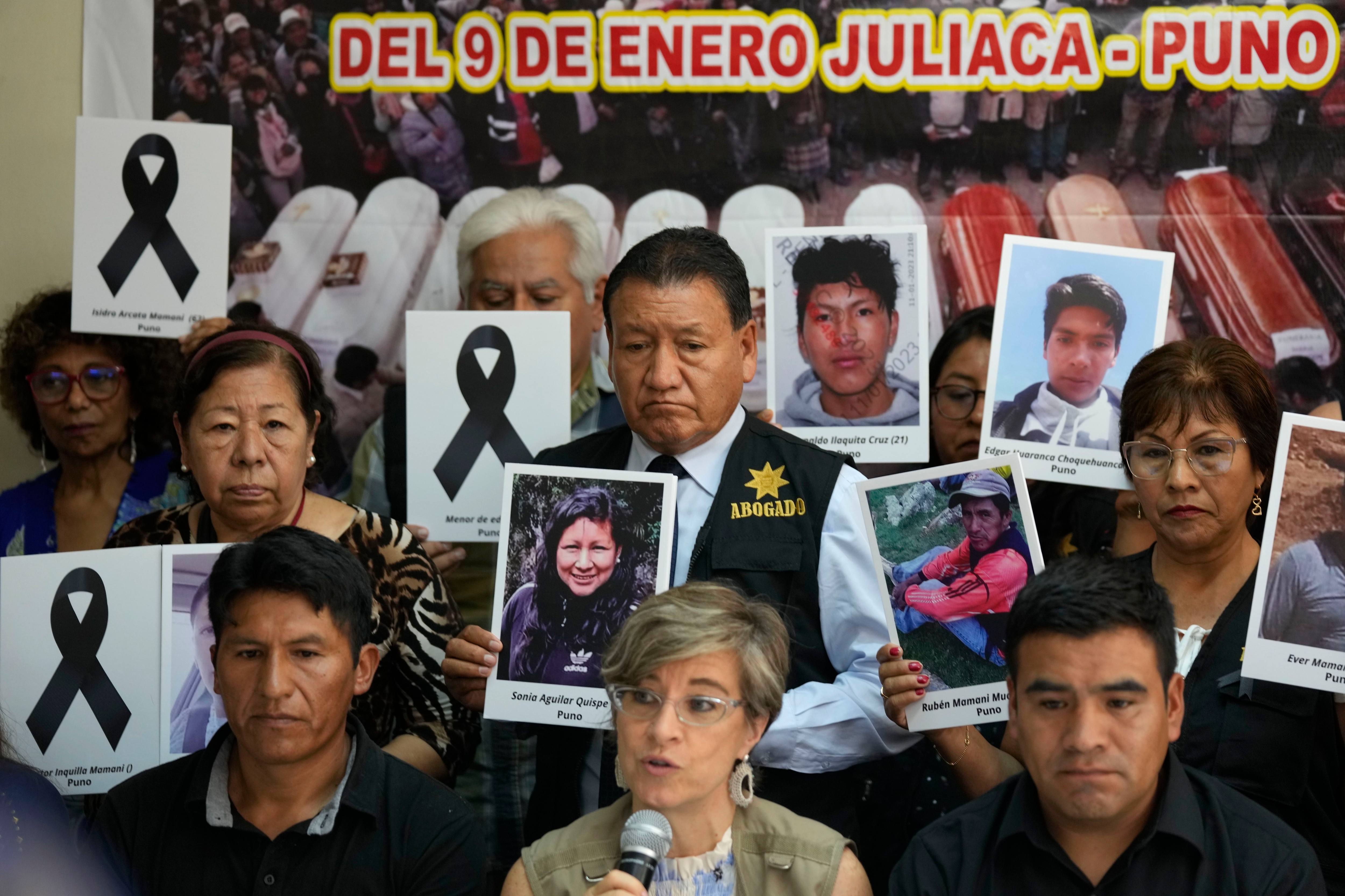Relatives of demonstrators killed in the protests show photos of the victims at a news conference in Lima, Peru, Thursday, February 23, 2023. Peru is in the midst of a political crisis as government critics call for the resignation of President Dina Boluarte and members of Congress, after former President Pedro Castillo was ousted in December and arrested for trying to dissolve Congress.  (AP Photo/Martín Mejía)
