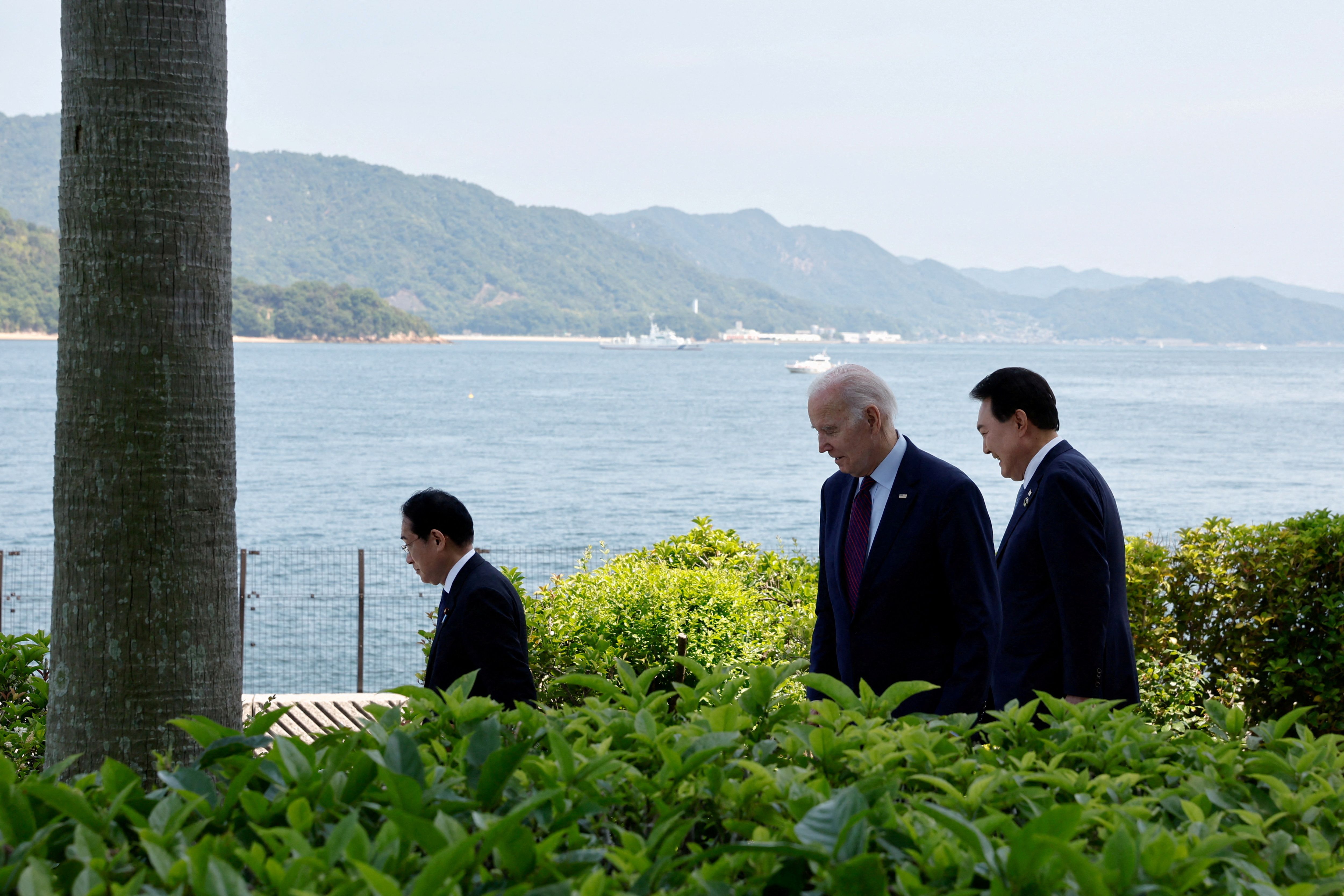 US President Joe Biden walks with Japan's Prime Minister Fumio Kishida and South Korea's President Yoon Suk Yeol on trilateral engagement day during the G7 Summit at the Grand Prince Hotel in Hiroshima, Japan, May 21, 2023. REUTERS/Jonathan Ernst/File