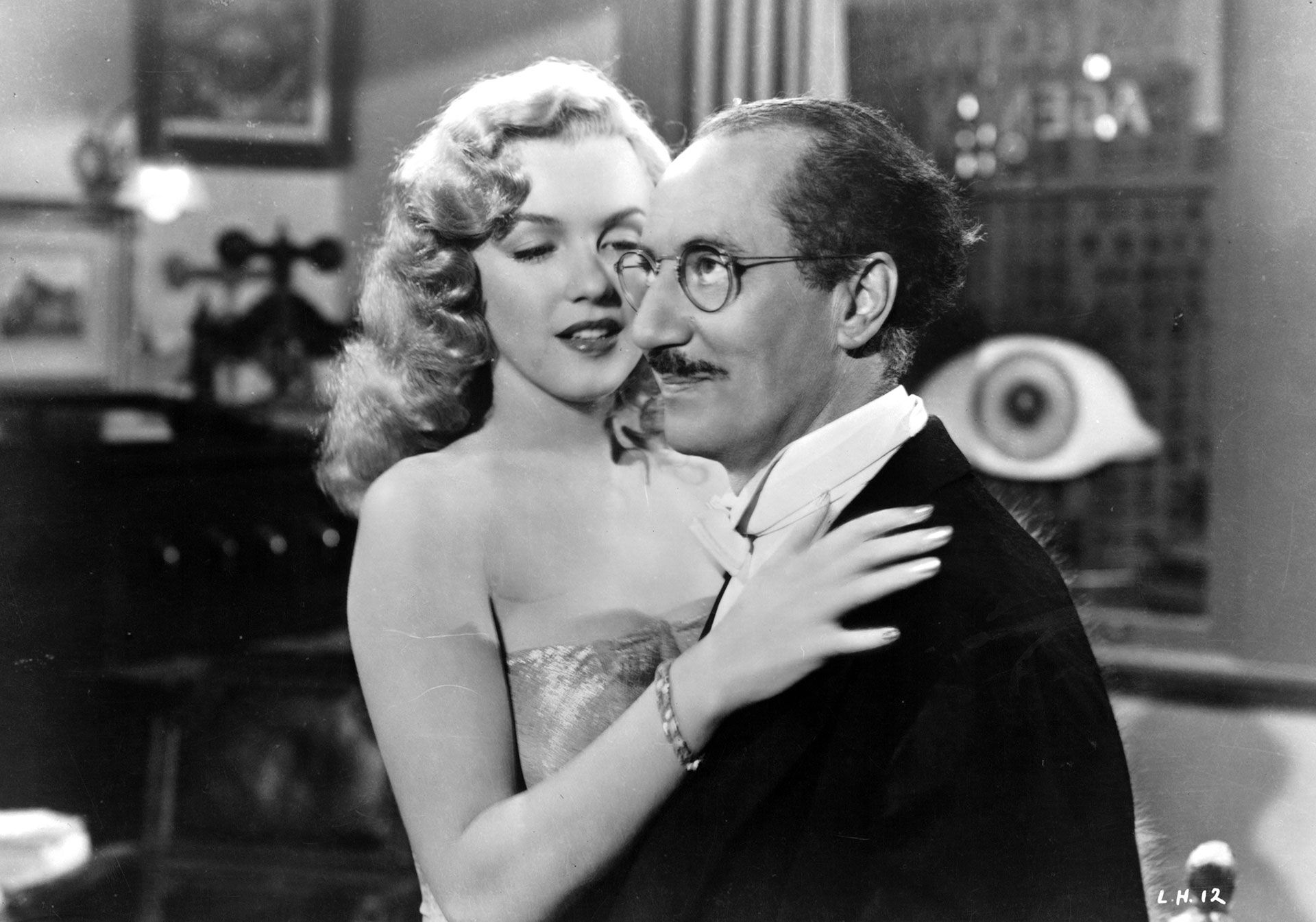 Groucho and Marilyn Monroe in a scene from Canned Love, from 1949. The comedian once asked that, when he died, his coffin be turned upside down against Marilyn's (Getty)