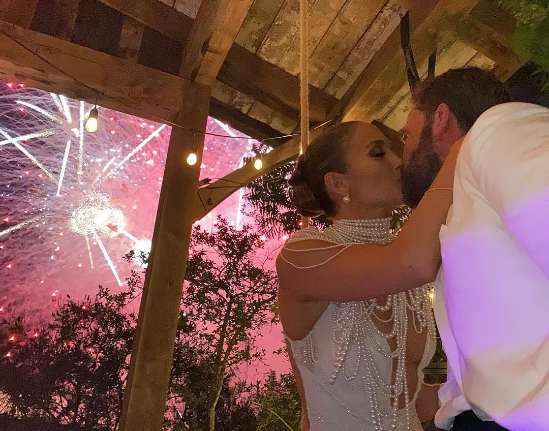 Jennifer Lopez and Ben Affleck sharing a kiss at their wedding with fireworks in the background Photo: Instagram/Jennifer Lopez