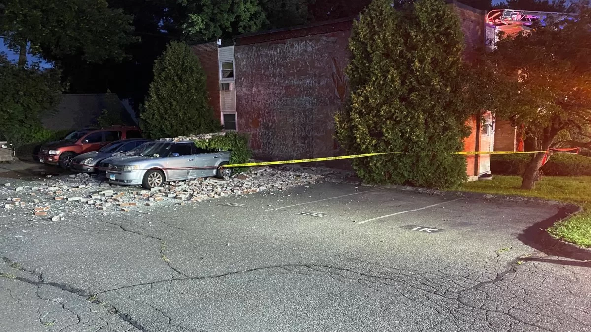 Building collapse damages cars, sends firefighter to hospital in Manchester
