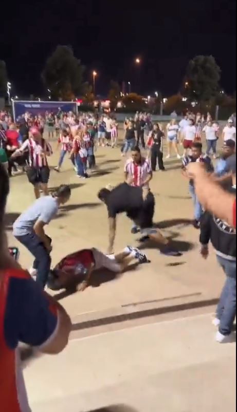 The fan was left on the ground after being hit by the subject in the black shirt.