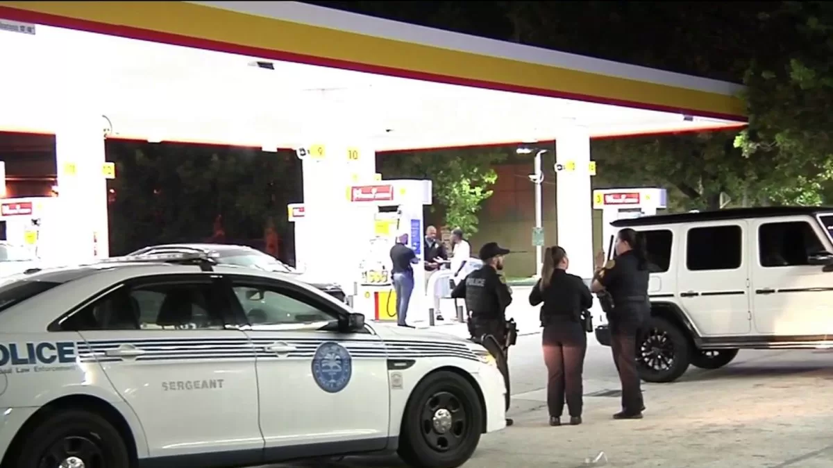 Investigating armed robbery at a Miami gas station
