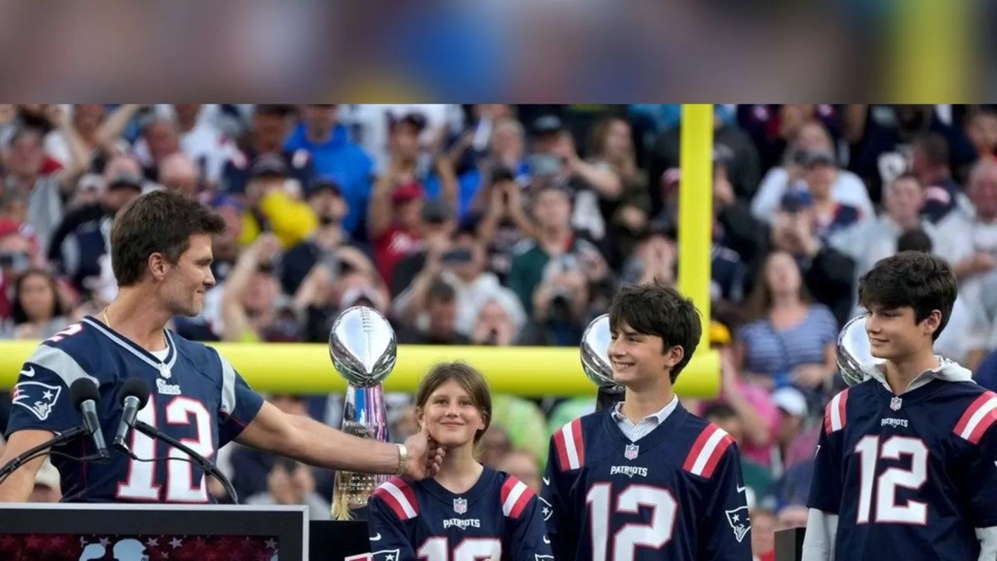 You are currently viewing Tom Brady: NFL star with children at a tribute in the stadium