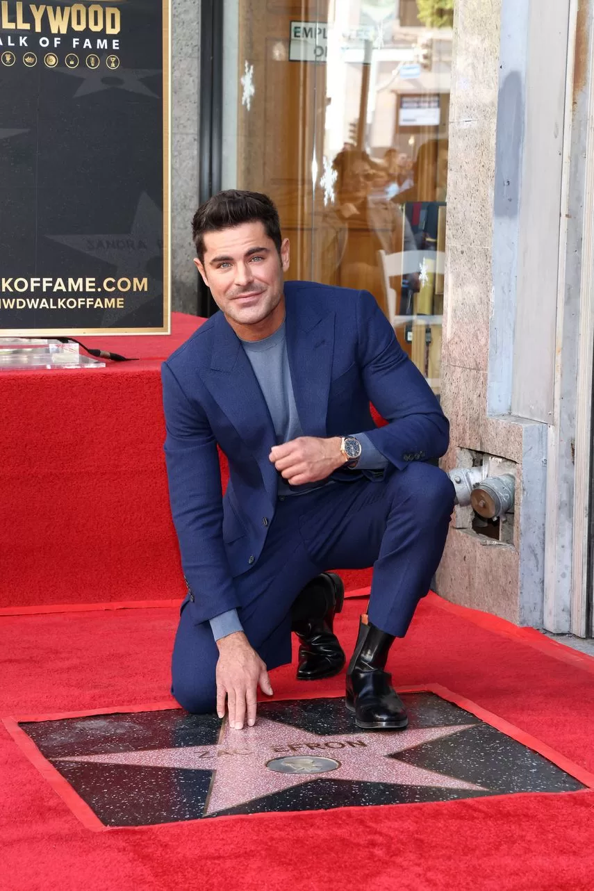 American actor Zac Efron poses with his newly revealed star during the Hollywood Walk of Fame ceremony in Hollywood, California, on December 11, 2023.