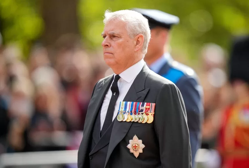 Britain's Prince Andrew, Duke of York, follows the coffin of Queen Elizabeth II, adorned with a royal banner and the imperial state crown and drawn by a royal horse artillery carriage of the king's troop, during a procession from Buckingham Palace to the Palace of Westminster, in London on September 14, 2022. 