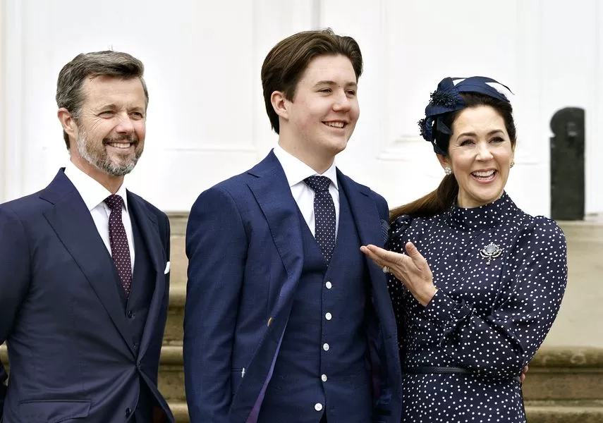 In this file photo, Prince Christina of Denmark stands between his parents, Crown Prince Frederick and Crown Princess Mary, at Fredensborg Castle Church in Fredensborg, Denmark, May 15, 2021.  