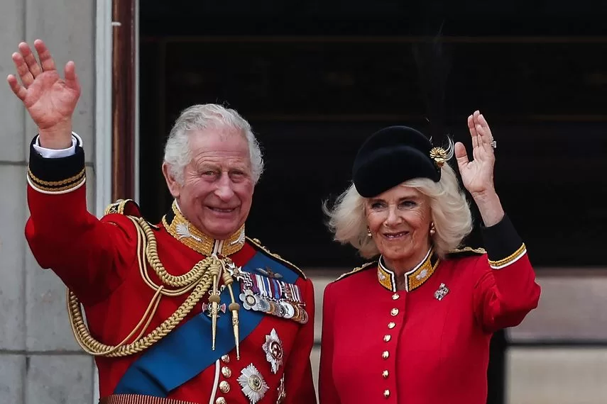 Britain's King Charles III and Queen Camilla wave from the balcony of Buckingham Palace after attending the king's birthday parade, 'Trooping the Colour', in London on June 17, 2023.   
