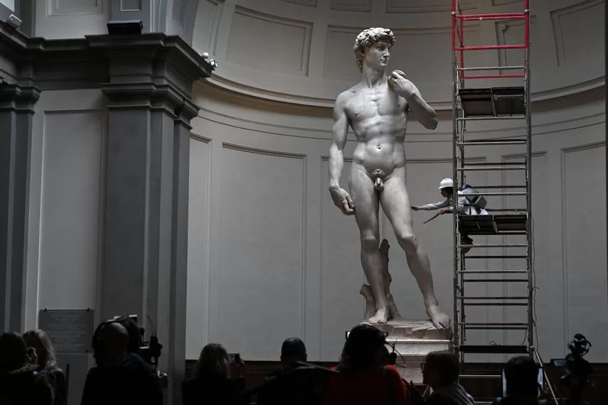 Italian restorer Eleonora Pucci cleans Michelangelo's statue of David using a backpack vacuum cleaner and a synthetic fiber brush at the Galleria dell'Accademia in Florence on February 19, 2024.  