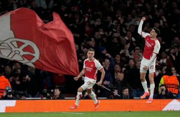 Leandro Trossard (center) celebrates with Kai Havertz after scoring Arsenal's second goal against Bayern Munich in the Champions League quarterfinals, Tuesday, April 9, 2024, in London. 