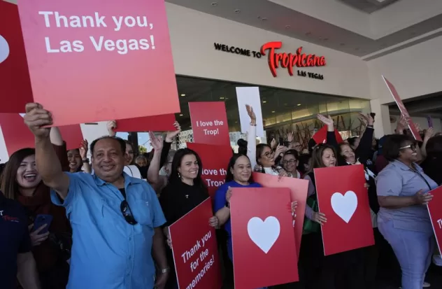 Employees of the Tropicana hotel and casino hold signs during a ceremony marking the closing of the historic site on Tuesday, April 2, 2024, in Las Vegas.