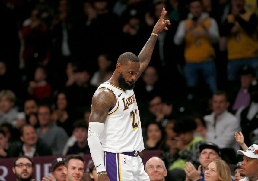 Los Angeles Lakers forward LeBron James receives recognition from the fans as he heads to the bench in the final moments of the final period of the basketball game against the Brooklyn Nets, Sunday, March 31, 2024, in New York. 
