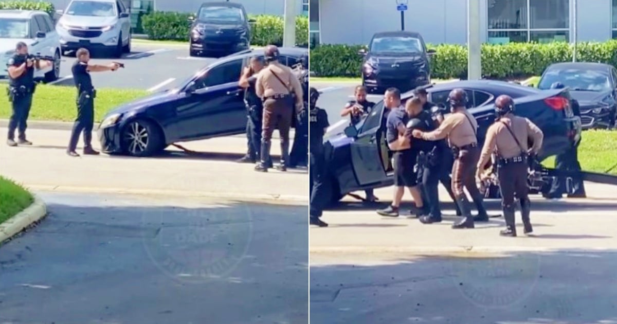 Dramatic police deployment to arrest man barricaded in car that was going to be towed in Miami
