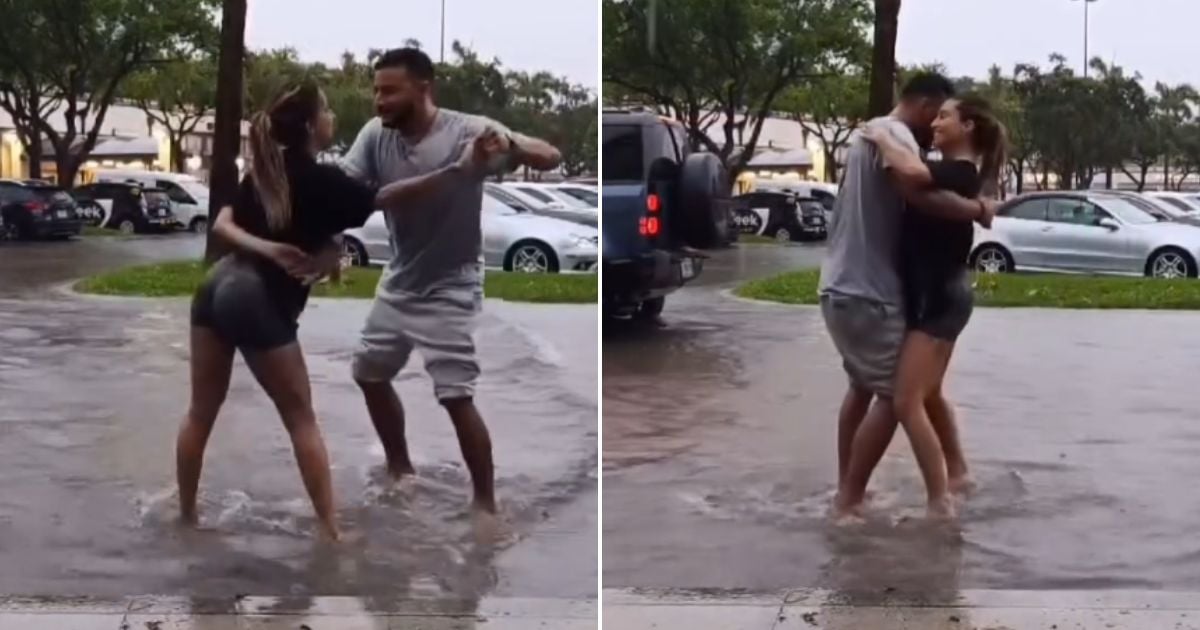 Couple dances bachata in the rain in Miami
