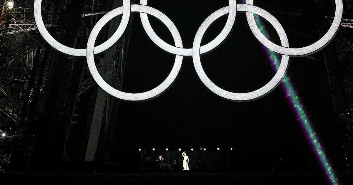 Celine Dion dazzles from the Eiffel Tower at the Olympic Games