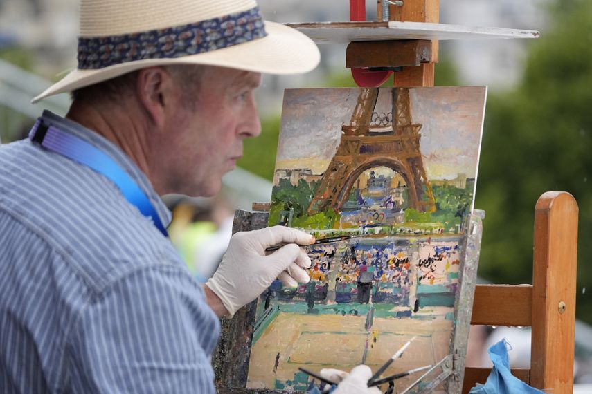 Peter Spens of London, England, paints at the Eiffel Tower Stadium during a beach volleyball match at the 2024 Summer Olympics, Saturday, July 27.